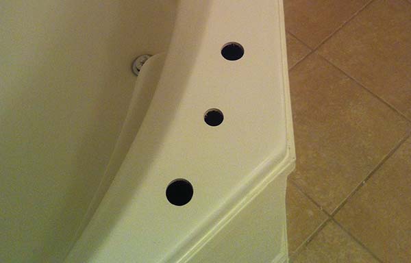 Tub deck with misdrilled holes for plumbing